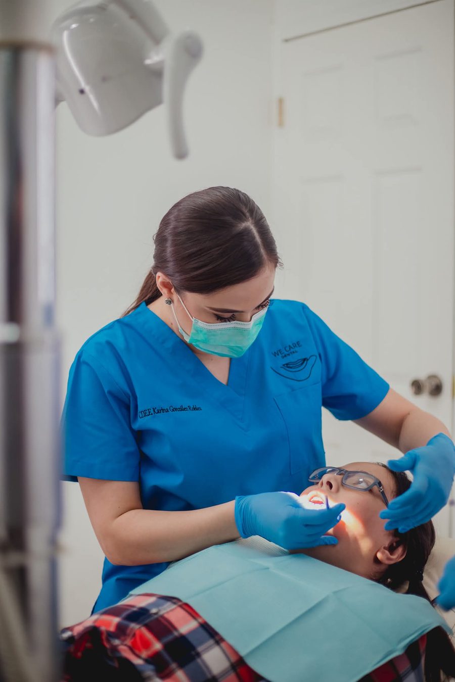 Dentist examining a patient during a general consultation